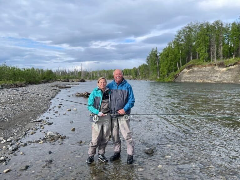 Couples fly fishing in Alaska at a remote river at Wilderness Place Lodge.